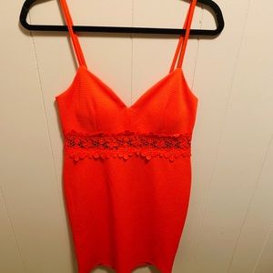 Coral colored dress with lace accents.